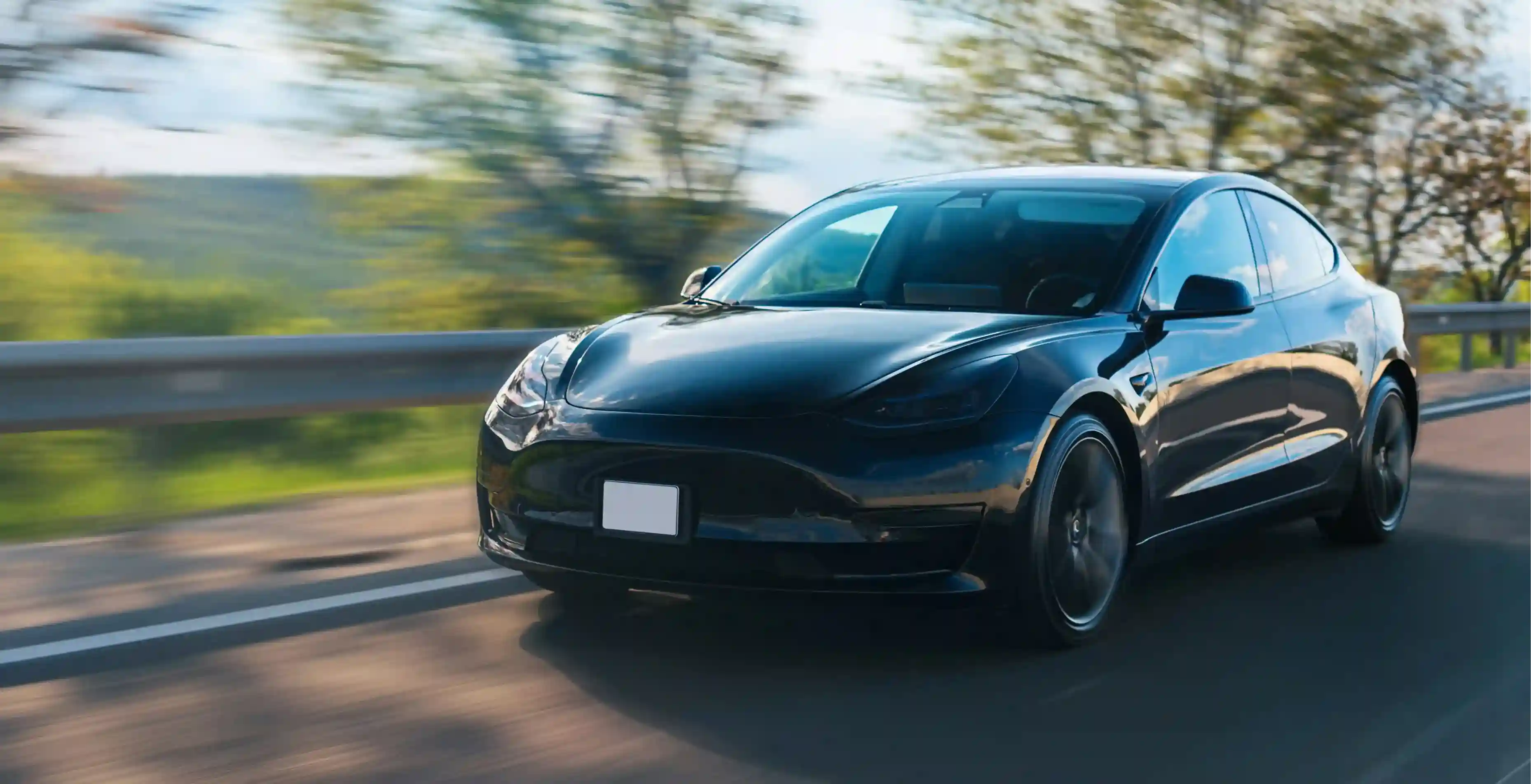 Luxury car on a road, representing mobile auto detailing